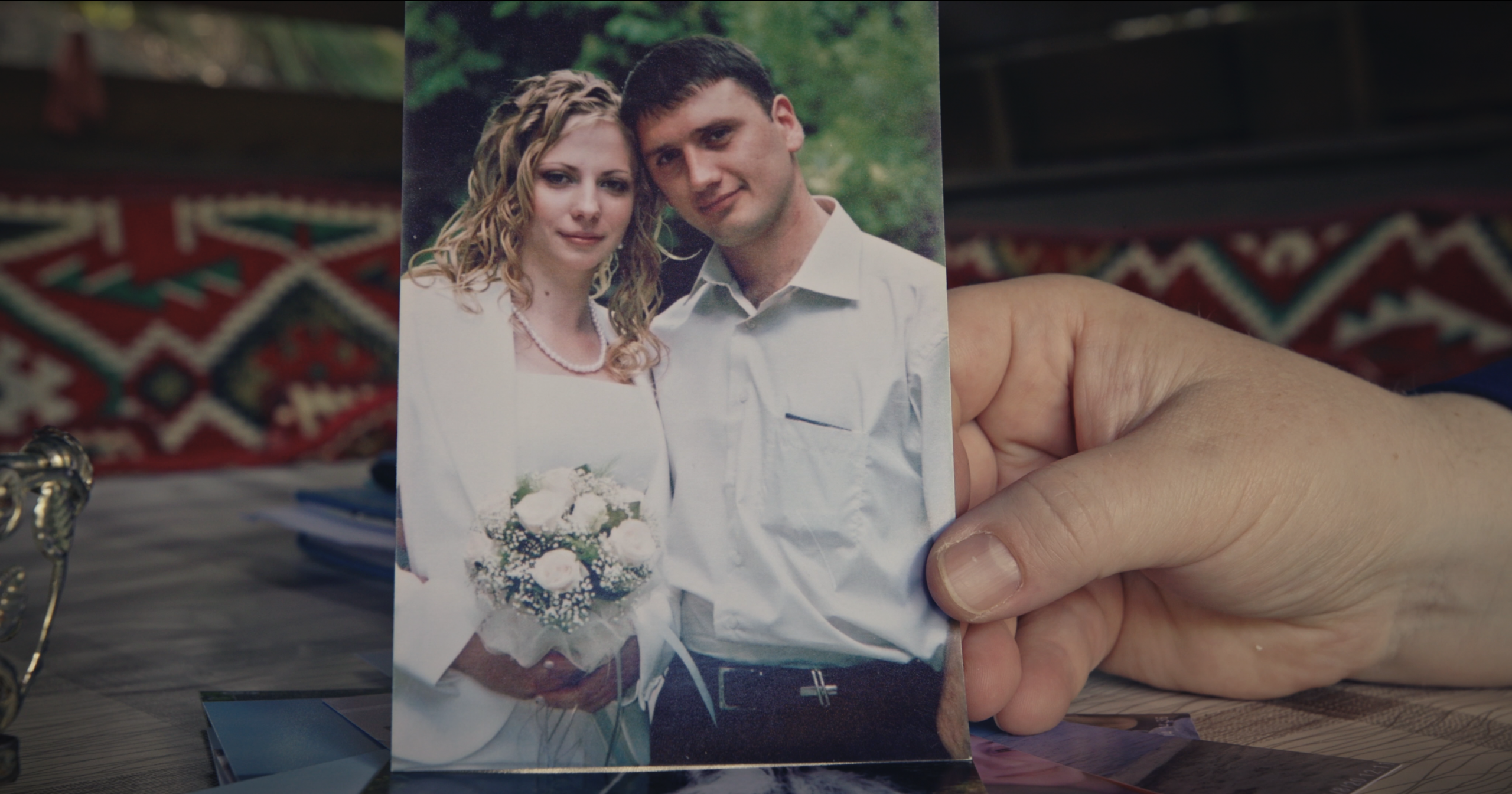 Elena Kadyrova shows a photograph from her wedding day, remembering the life she built with her husband, Seyran, before Russia’s occupation of Crimea and the subsequent full-scale war.