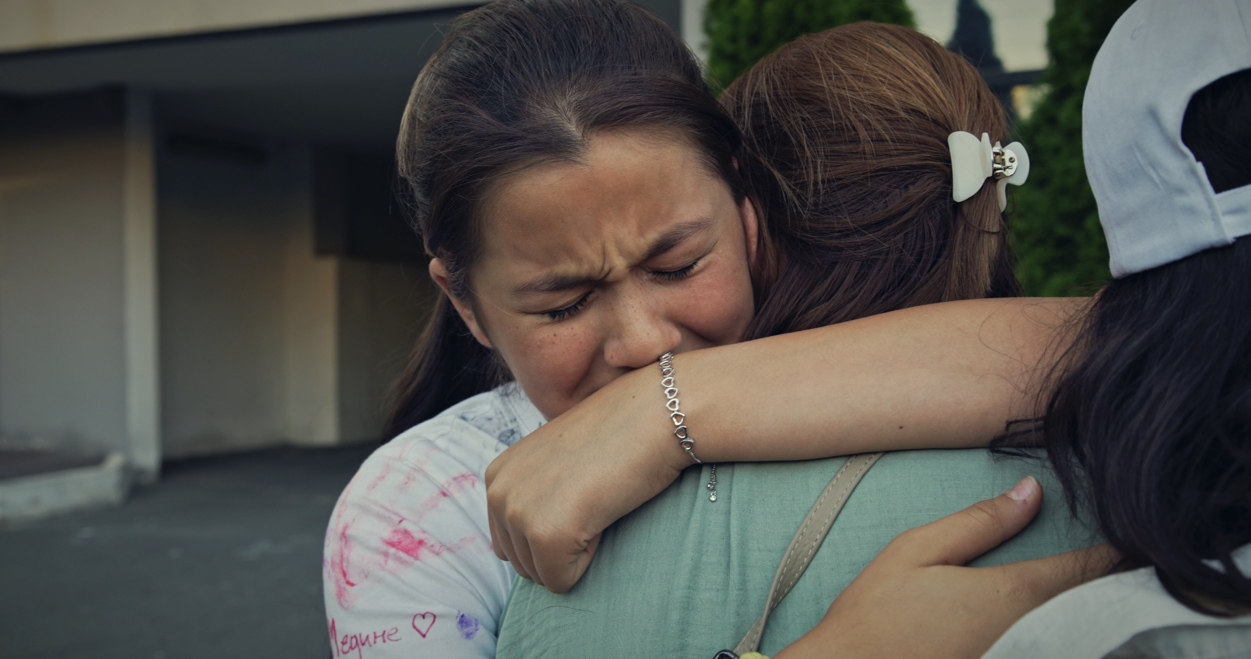 Nariman Dzhelyal’s daughter and wife hug after the political activist is finally freed.