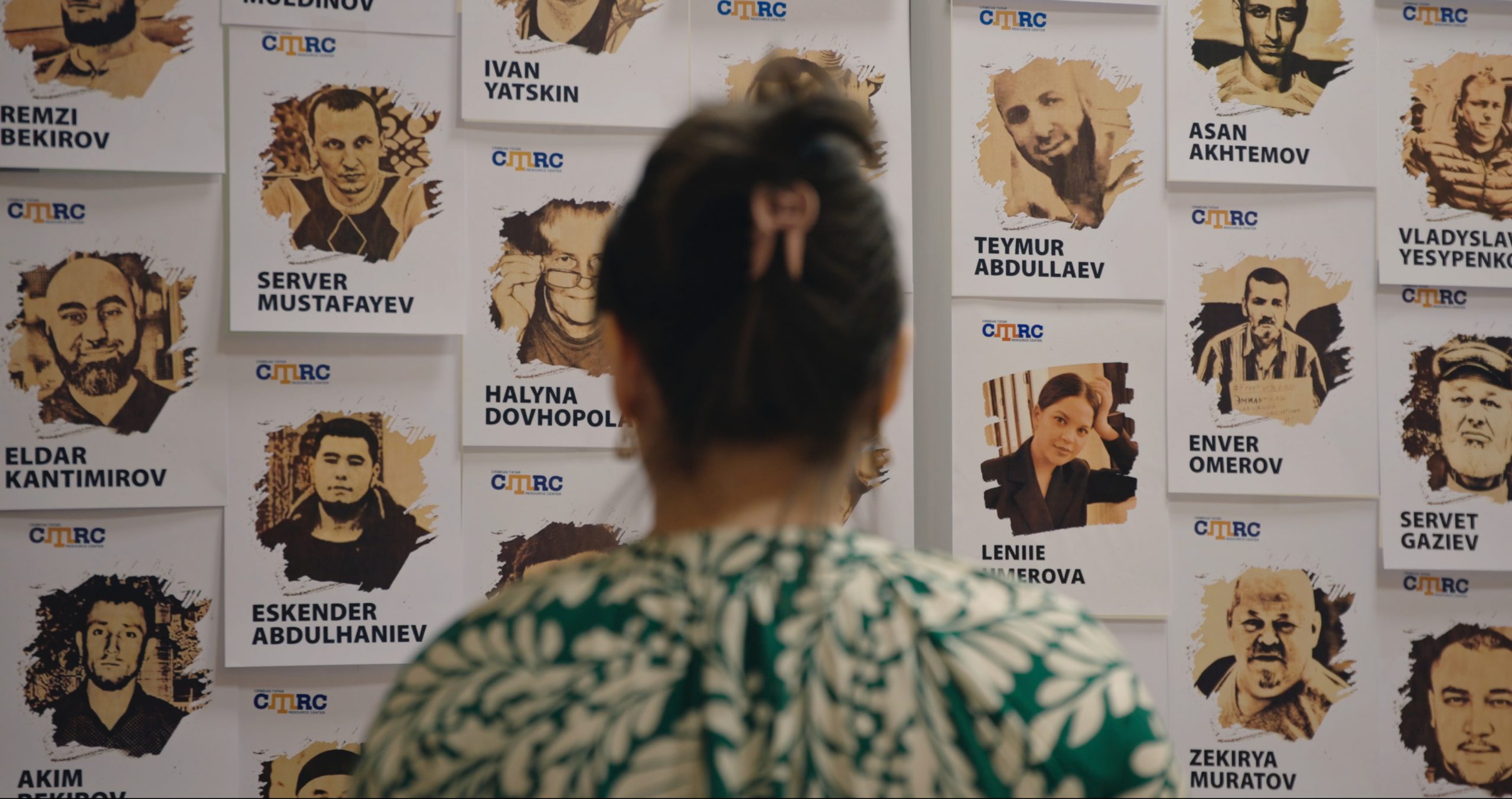 Zarema Bariieva stands before the Crimean Tatar Resource Center’s wall of political prisoners, surrounded by the faces of those unjustly detained under the Russian occupation in Crimea. She and her husband, Eskender, continue their efforts to free them.