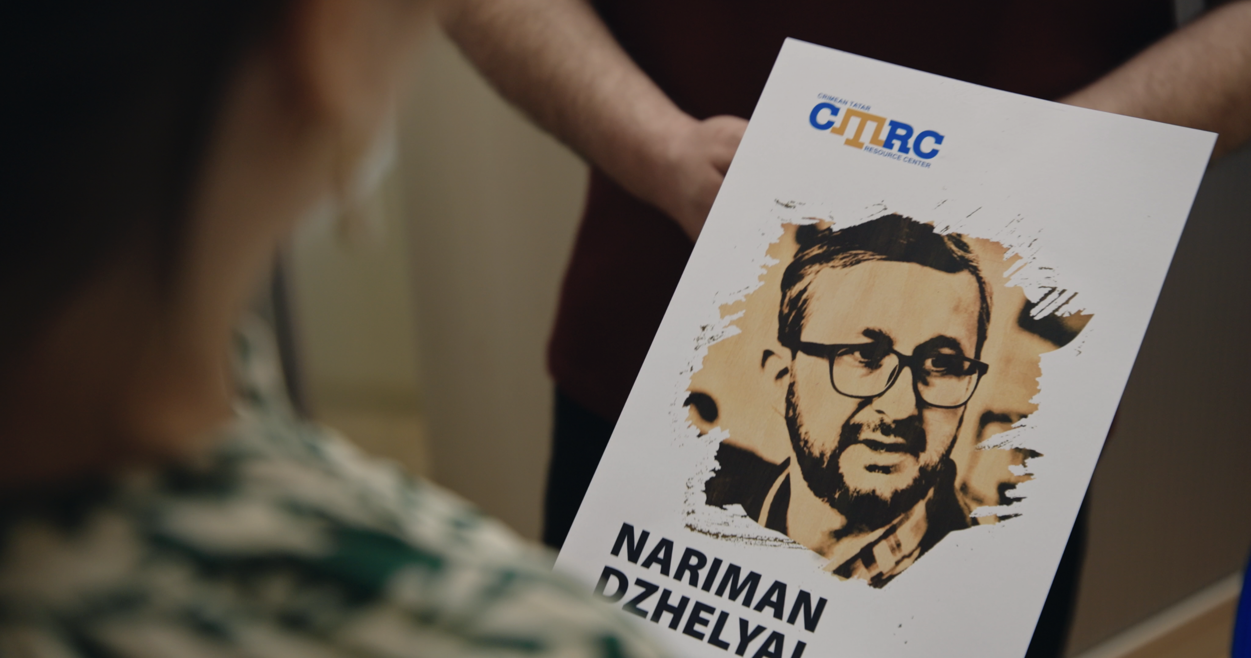 Zarema Bariieva holds a poster of Nariman Dzhelyal, who spent three years in a Russian prison after speaking out against human rights violations in Crimea.